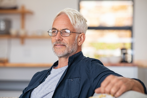 man with glasses relaxing on a chair