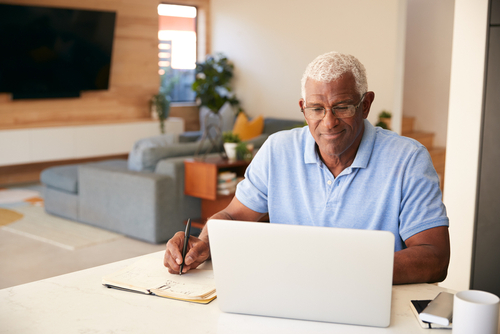 man taking notes at desk
