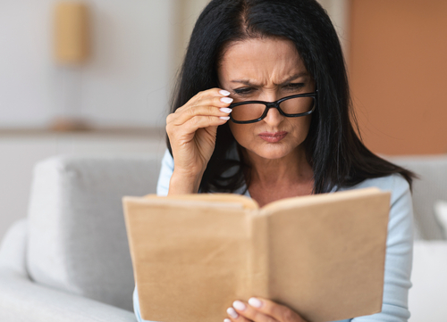 woman in glasses reading a book 