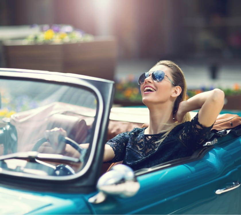 Young woman enjoying joyride in car