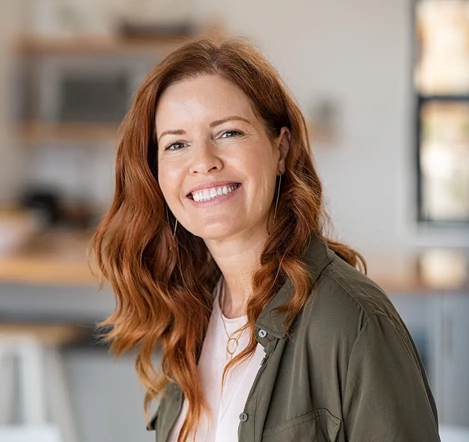 Portrait of smiling mature woman looking at camera with big grin