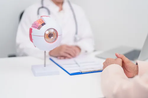 doctor explaining to a patient in doctor office with eye diagram