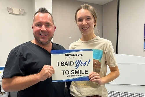 Dr. Marius Gradianu, D.O. standing with patient holding a sign.